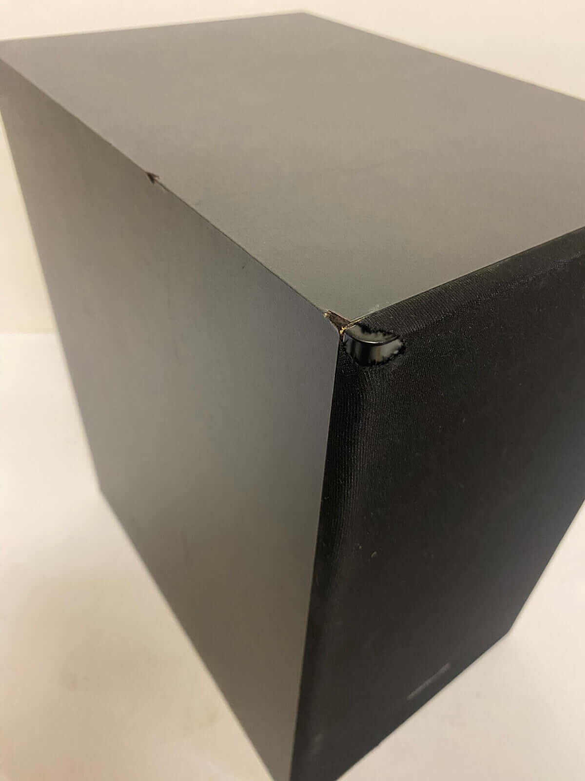 Close-up view of Samsung HW-T550 soundbar showing a sleek black design and corner details.