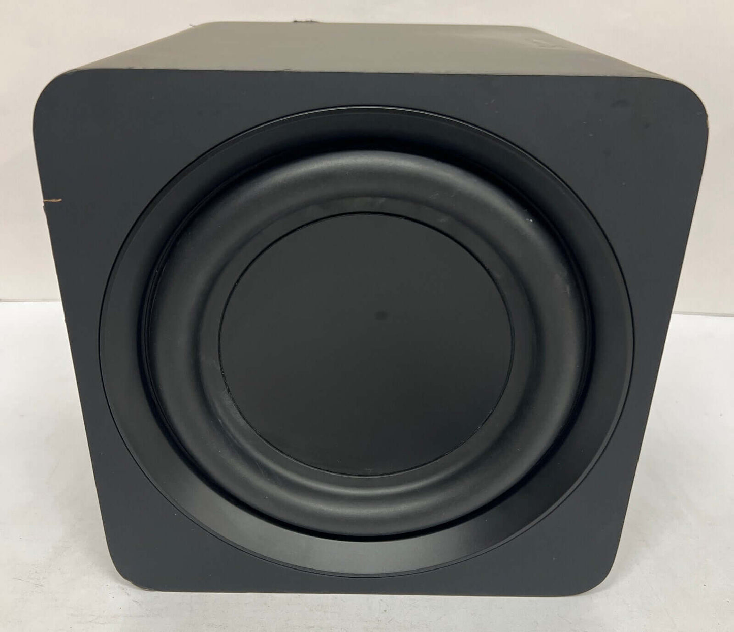 Black soundbar subwoofer front view with round speaker grill, designed for immersive audio experience.