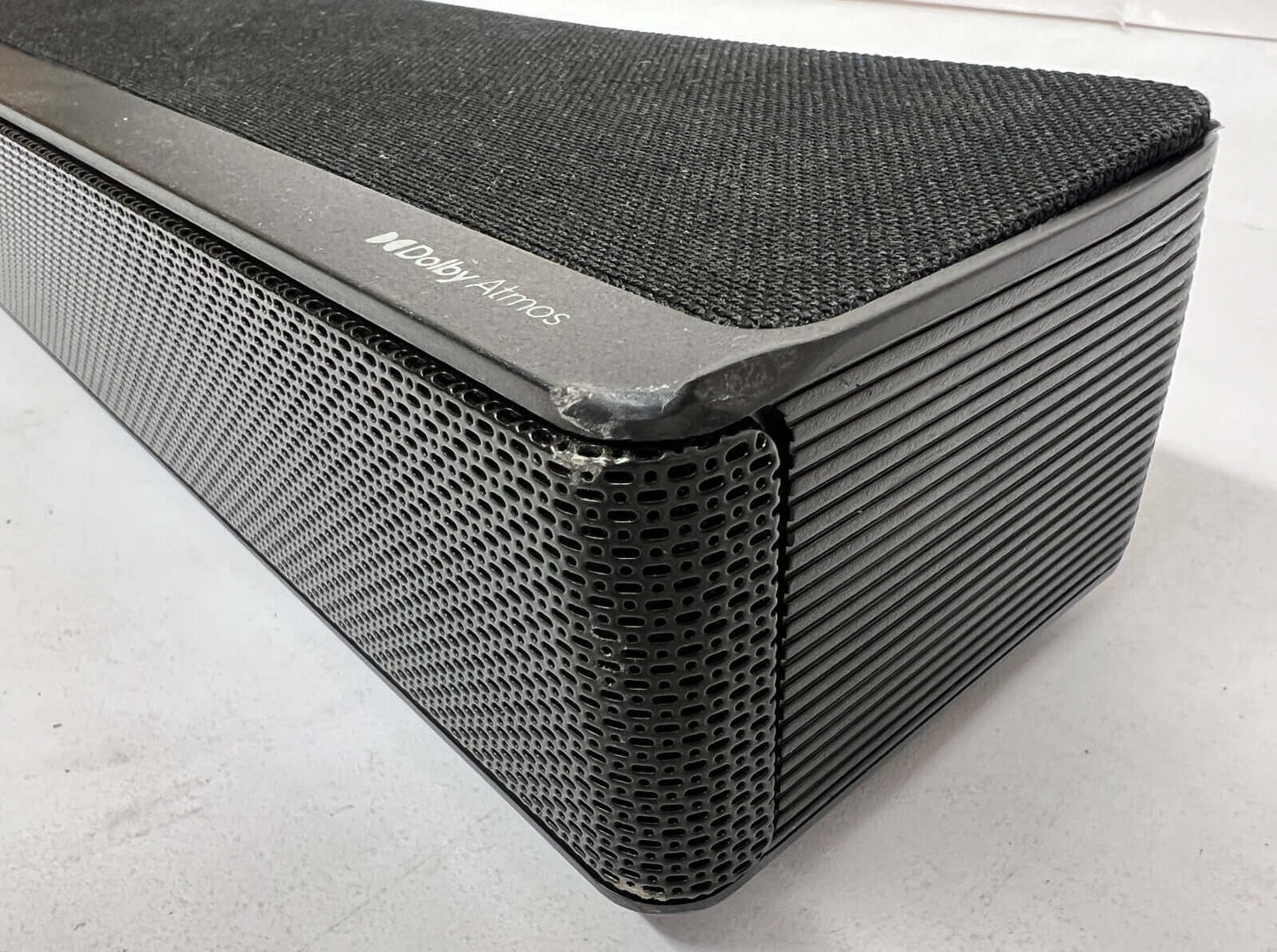 Close-up of Hisense AX3120G wireless soundbar, featuring Dolby Atmos and a sleek black design.