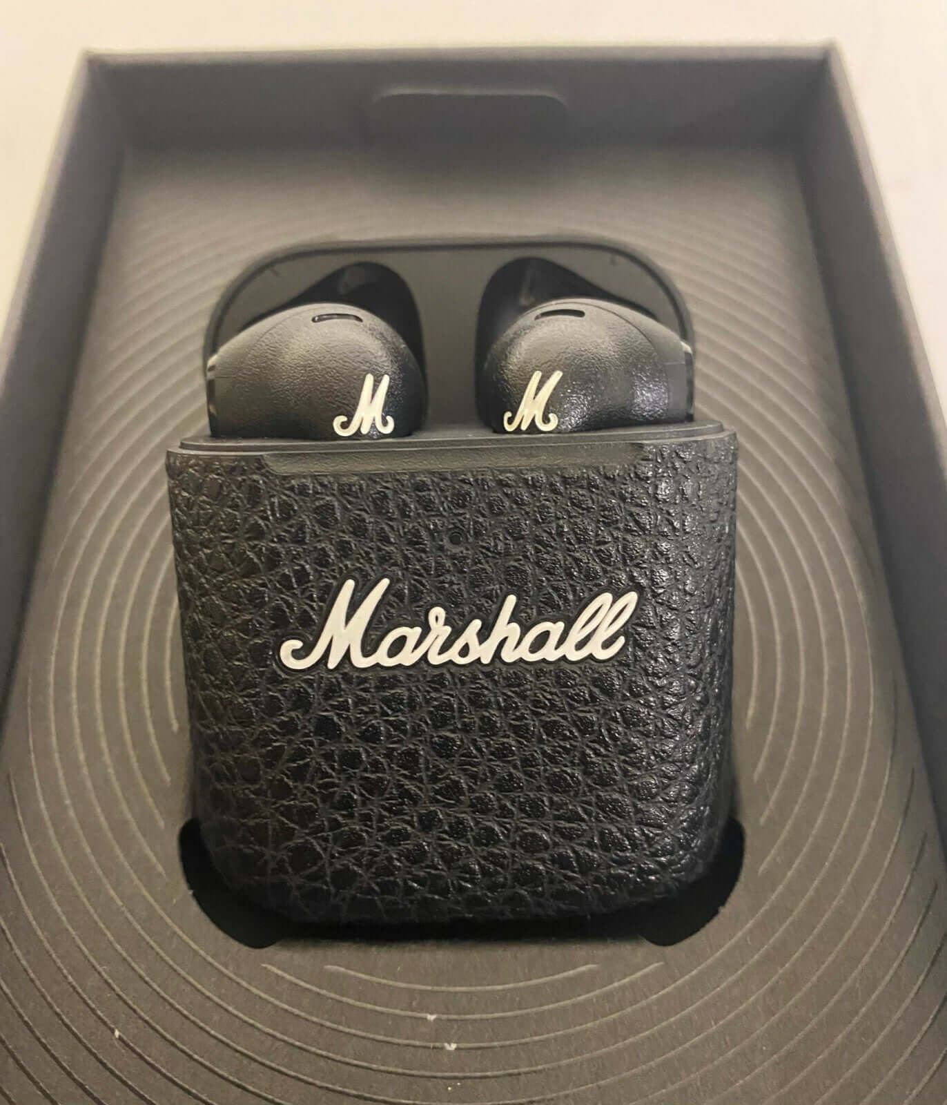 Marshall Minor III True Wireless Earbuds in black charging case, featuring iconic logo and stylish design.