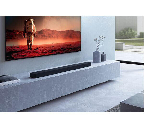 SONY BRAVIA HT-A9000 soundbar displayed in a modern living room with a large TV showing an astronaut scene.