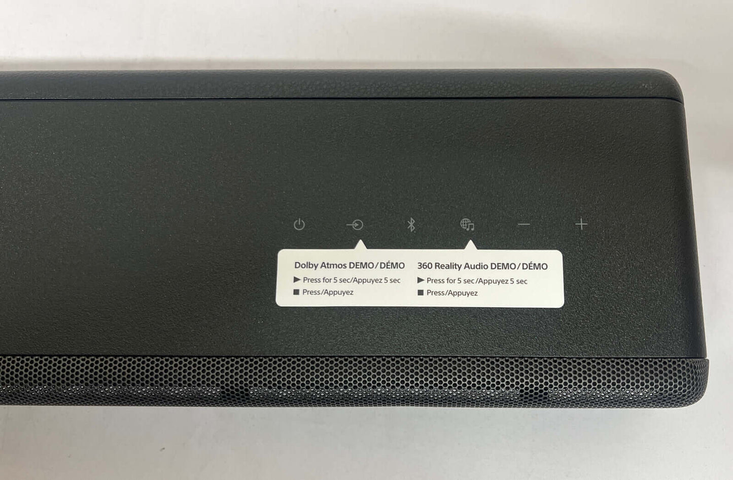 Top view of SONY HT-A3000 soundbar displaying control buttons and demo labels for Dolby Atmos and 360 Reality Audio.