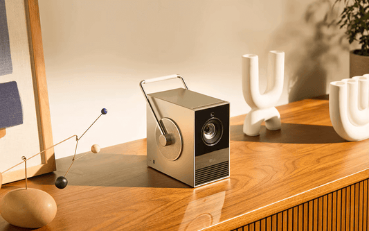 Introducing the LG HU710PB CineBeam 4K Projector displayed elegantly on a wooden table with modern decor.