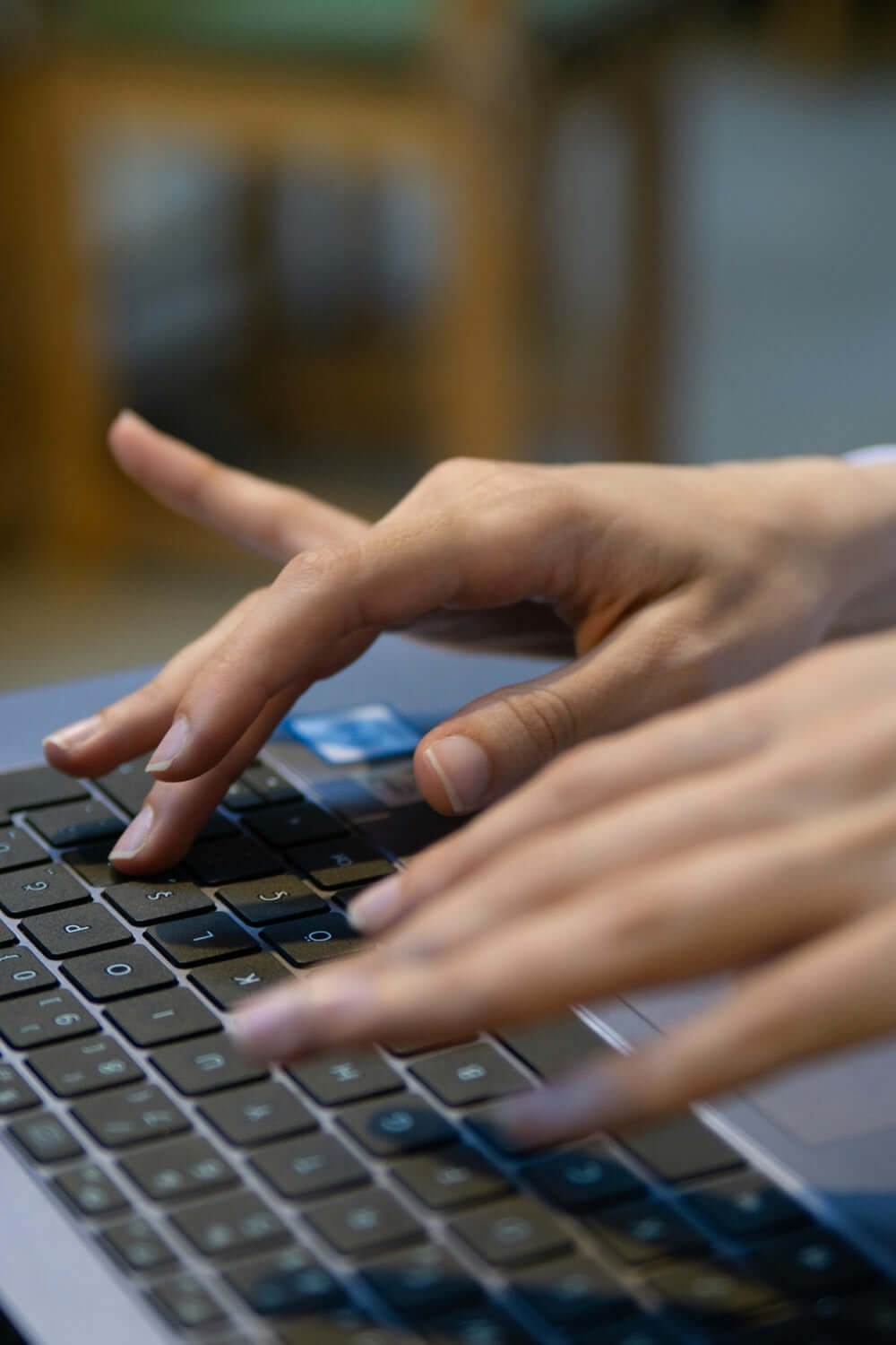 Hands typing on a new laptop keyboard for optimum performance.