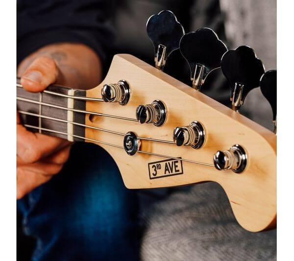 3RD AVENUE 4/4 electric bass guitar bundle with amp showcasing the headstock and tuning pegs.
