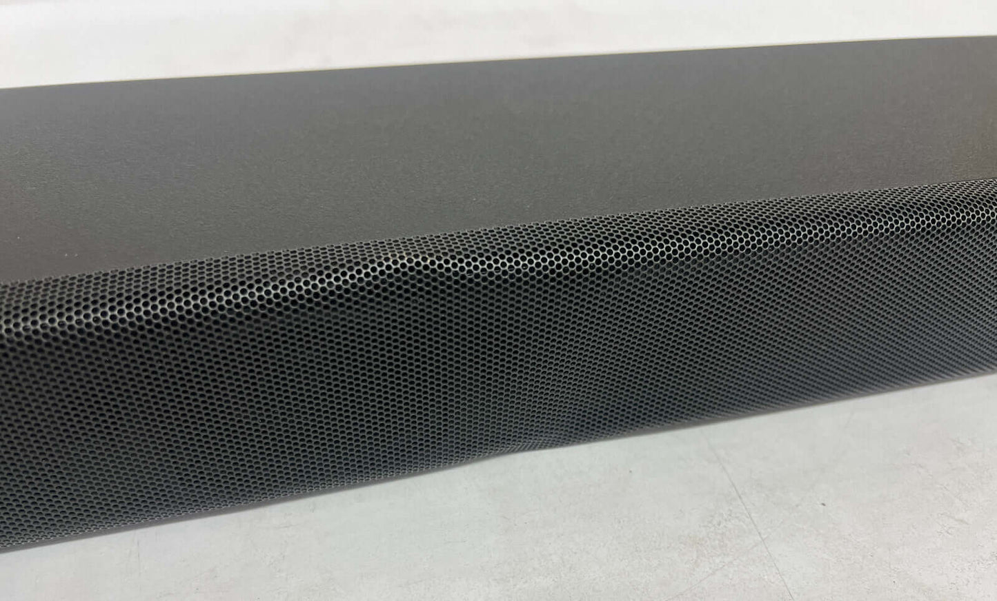 Close-up of the SONY HT-A5000 soundbar with a sleek black design and perforated speaker grille.