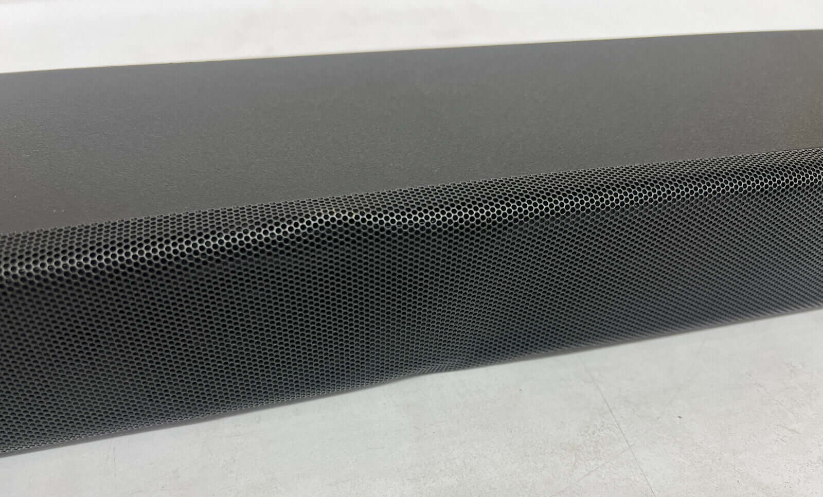 Close-up of the SONY HT-A5000 soundbar with a sleek black design and perforated speaker grille.