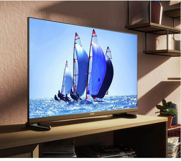 Philips 32PHS6808 Smart LED TV displaying a sailing scene in a living room setting.