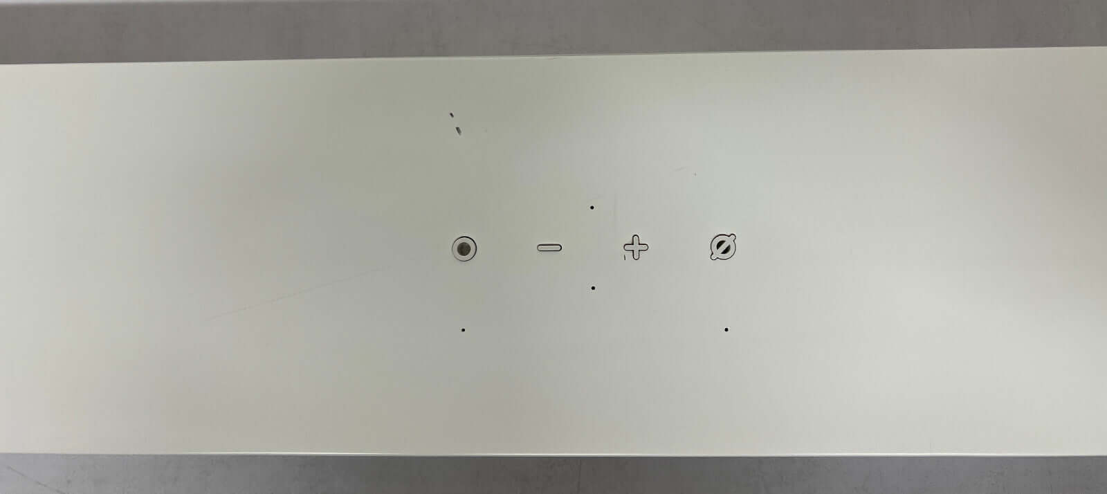 Top view of the SAMSUNG HW-S61B soundbar showing control buttons for volume and power.