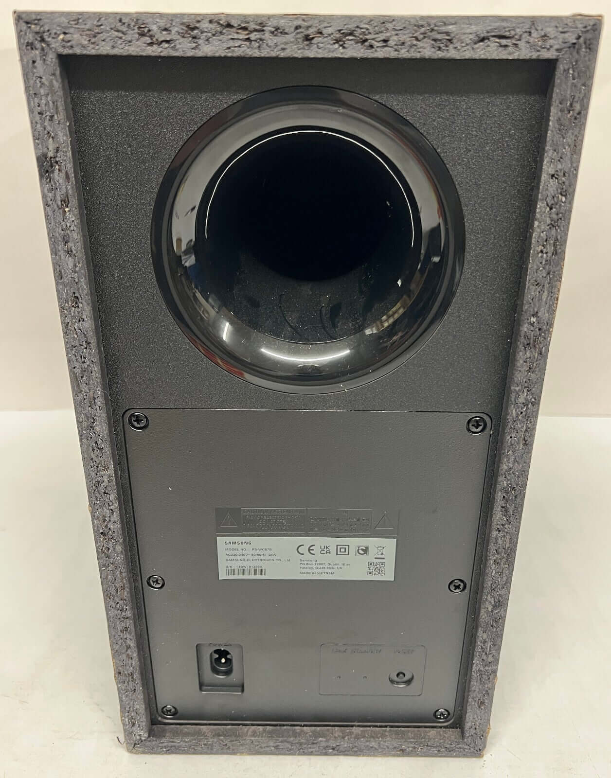 Back view of SAMSUNG HW-Q60C/XU wireless subwoofer showcasing port and connections.
