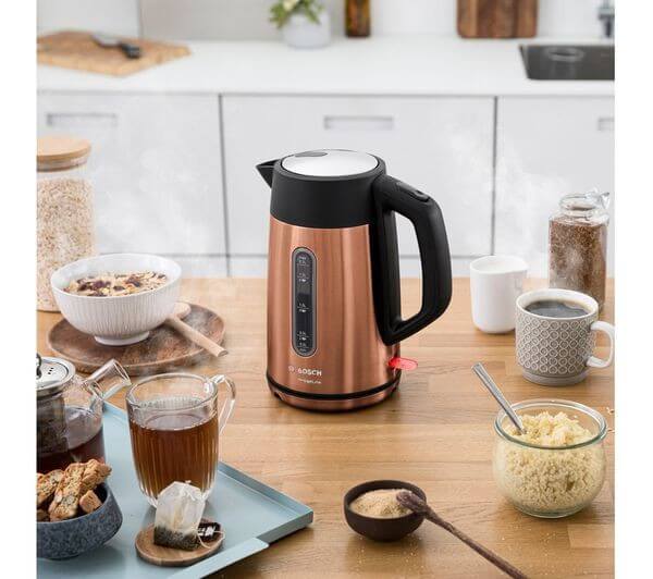 BOSCH DesignLine Plus TWK4P439GB 3000W 1.7L CORDLESS JUG ELECTRIC KETTLE COPPER placed on a kitchen table.
