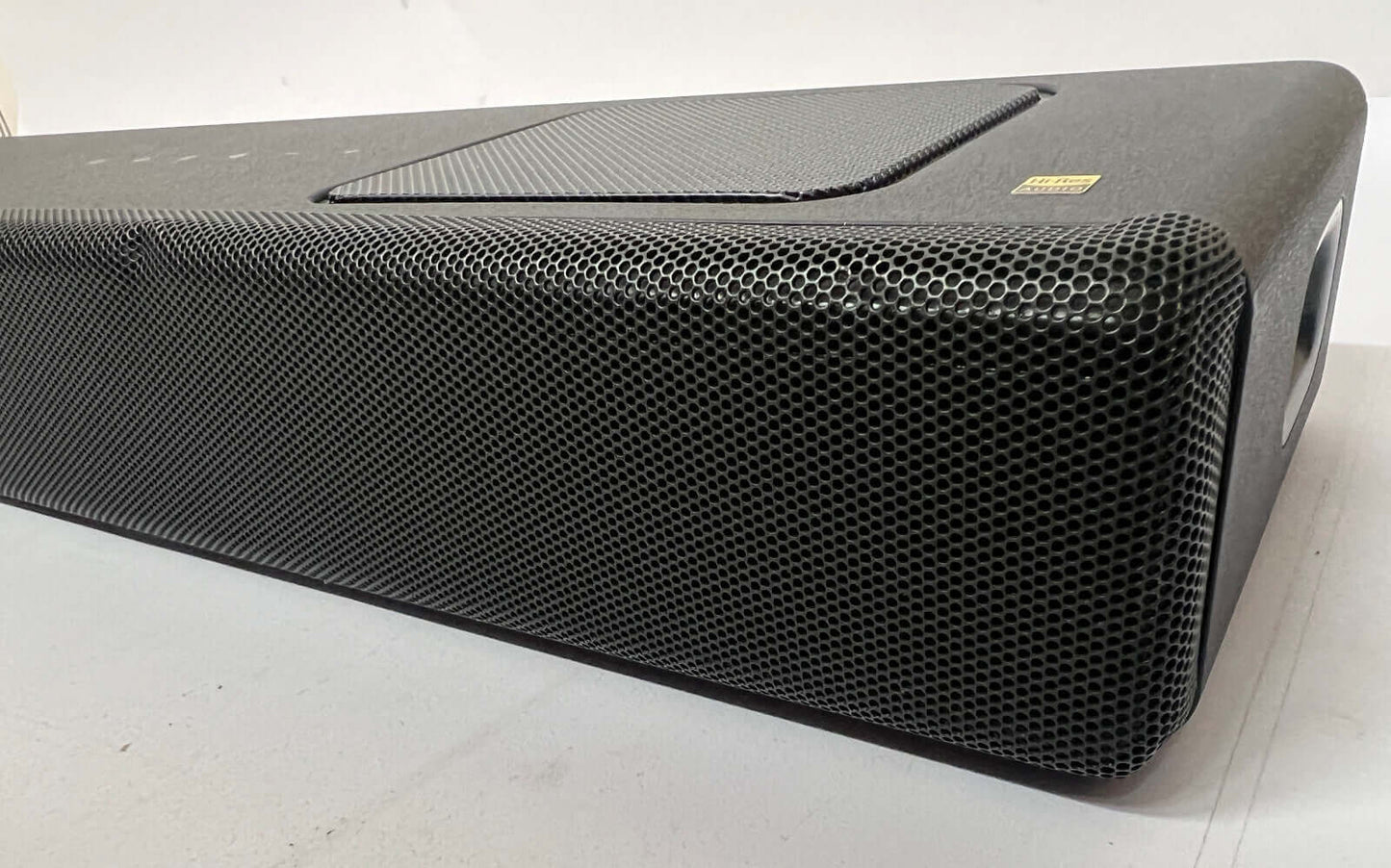 Side view of SONY HT-A5000 5.1.2 wireless soundbar showcasing its sleek design and mesh speaker front.