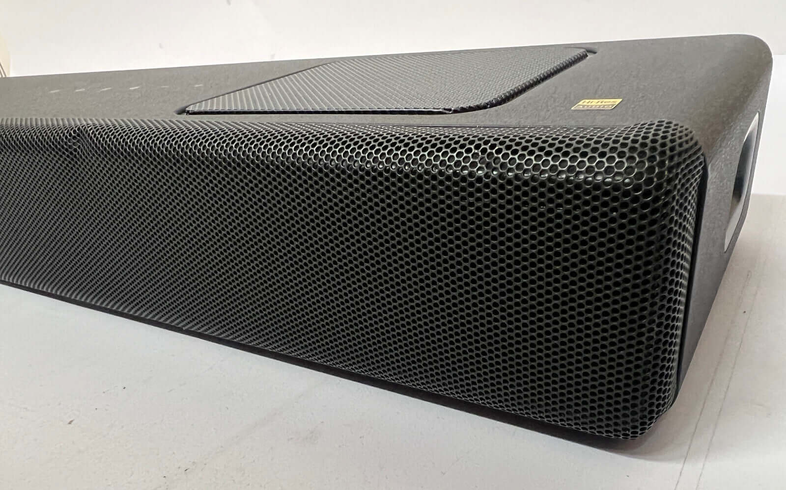 Side view of SONY HT-A5000 5.1.2 wireless soundbar showcasing its sleek design and mesh speaker front.