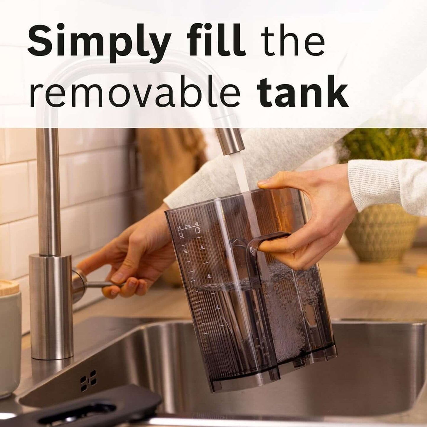 User filling the removable tank of the BOSCH MyMoment TKA2M113GB FILTER GROUND COFFEE MACHINE 10 CUP CAPACITY BLACK.