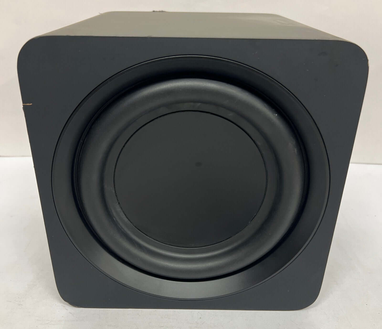 Black soundbar subwoofer front view with round speaker grill, designed for immersive audio experience.