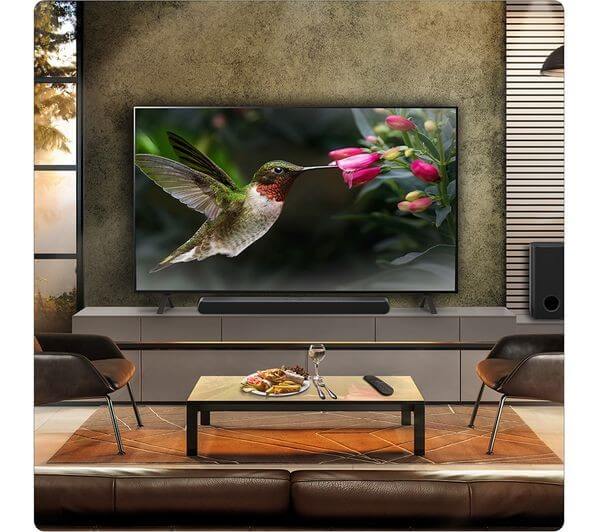LG US77TY SOUNDBAR HOME CINEMA 3.1.3 WIRELESS SUBWOOFER 4K DOLBY ATMOS RRP £899 displayed in a modern living room.