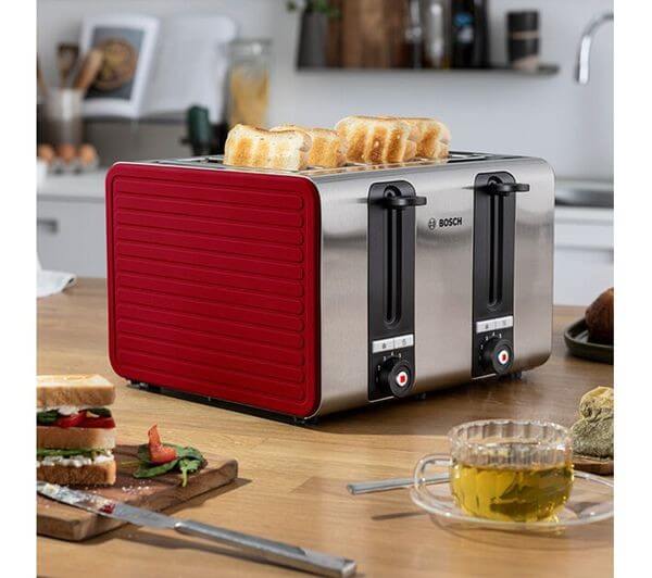 BOSCH SILICONE TAT7S44GB 1800W 4 SLICE TOASTER STAINLESS STEEL RED with toast on top and sandwiches beside.