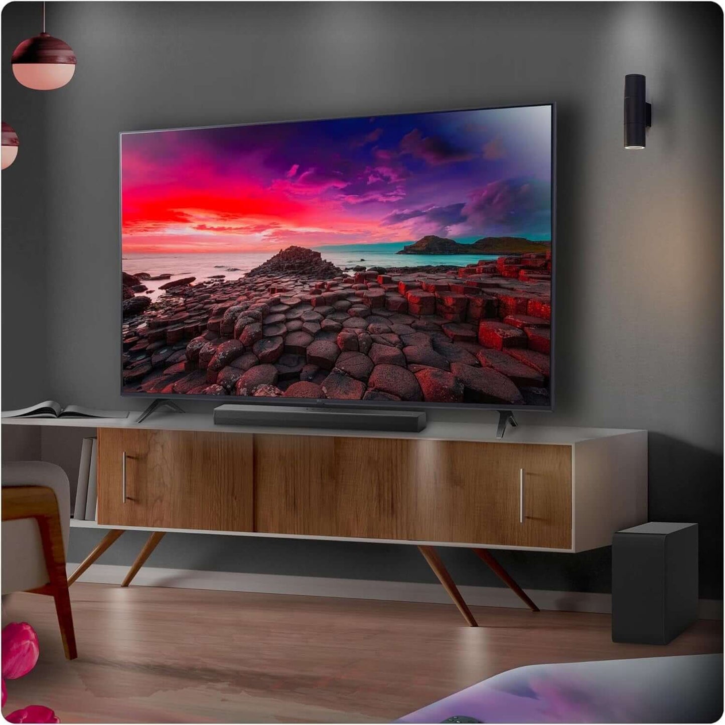 LG US40TR SOUNDBAR 4.1 400W WIRELESS SUBWOOFER BLUETOOTH HDMI AI SOUND PRO displayed under a TV in a modern living room.