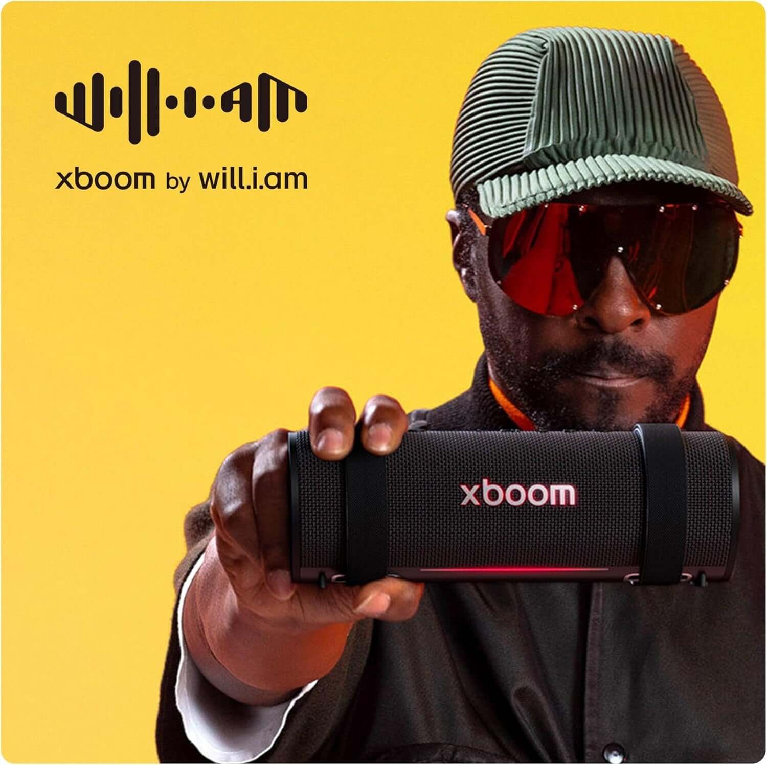 LG XBOOM Grab portable Bluetooth speaker showcased by a model, featuring a sleek black design and modern aesthetics.